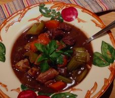 Beef stew served in a pretty apple bowl.