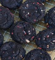 Dark chocolate and peppermint cookies cooling on a cooling rack.