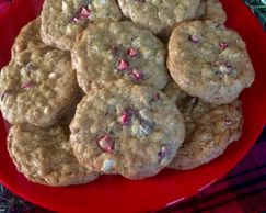 Cranberry white chocolate chip cookies on a red plate.
