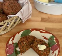 Zucchini carrot bran muffins served with butter.