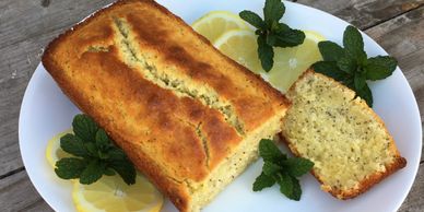 Lemon Poppy seed cake served on a platter with lemon slices and fresh mint.