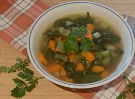 Immune boosting vegetable soup garnished with fresh parsley.