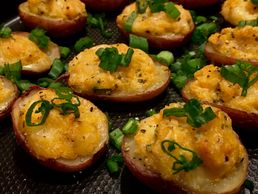 Mini twice baked potatoes topped with green onions.