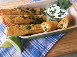 Poblano Potato Taquitos served in dish with jalapeno lime crema dipping sauce on the side.