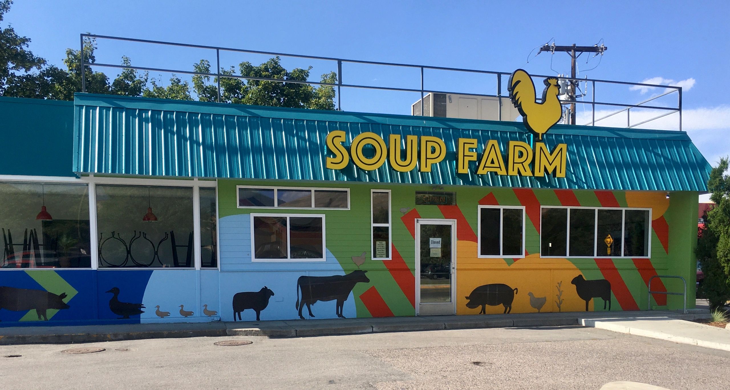 Full front facade of Soup Farm, painted with bright stripes and farm animal silhouettes 