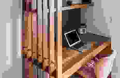A quaint corner desk with architectural divider for a dedicated look, while keeping it airy and open