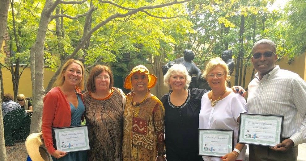 A judge holding 1st (mine), 2nd & 3rd place awards.