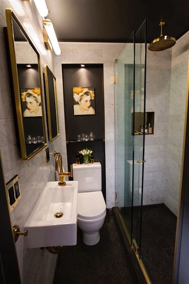 Completed modern bathroom renovation. Double medicine cabinets, Carrara marble, brass fixtures. 