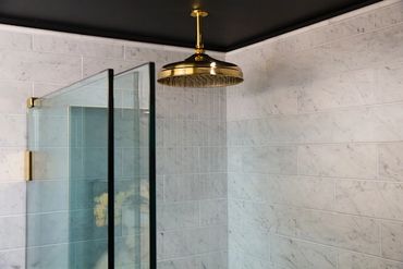 Shower glass doors, rain shower head. 