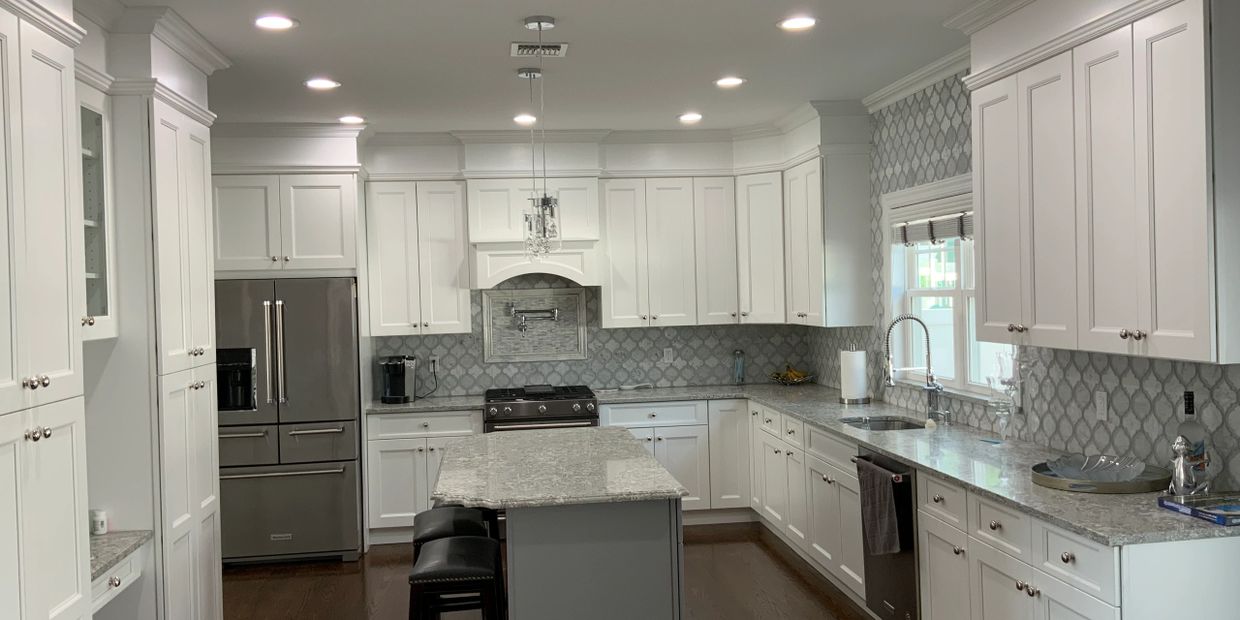 Spacious kitchen with center island, pot fill up fixture above the stove. 