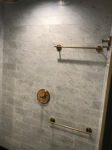 Carrara marble tiles/ Brass towel bars