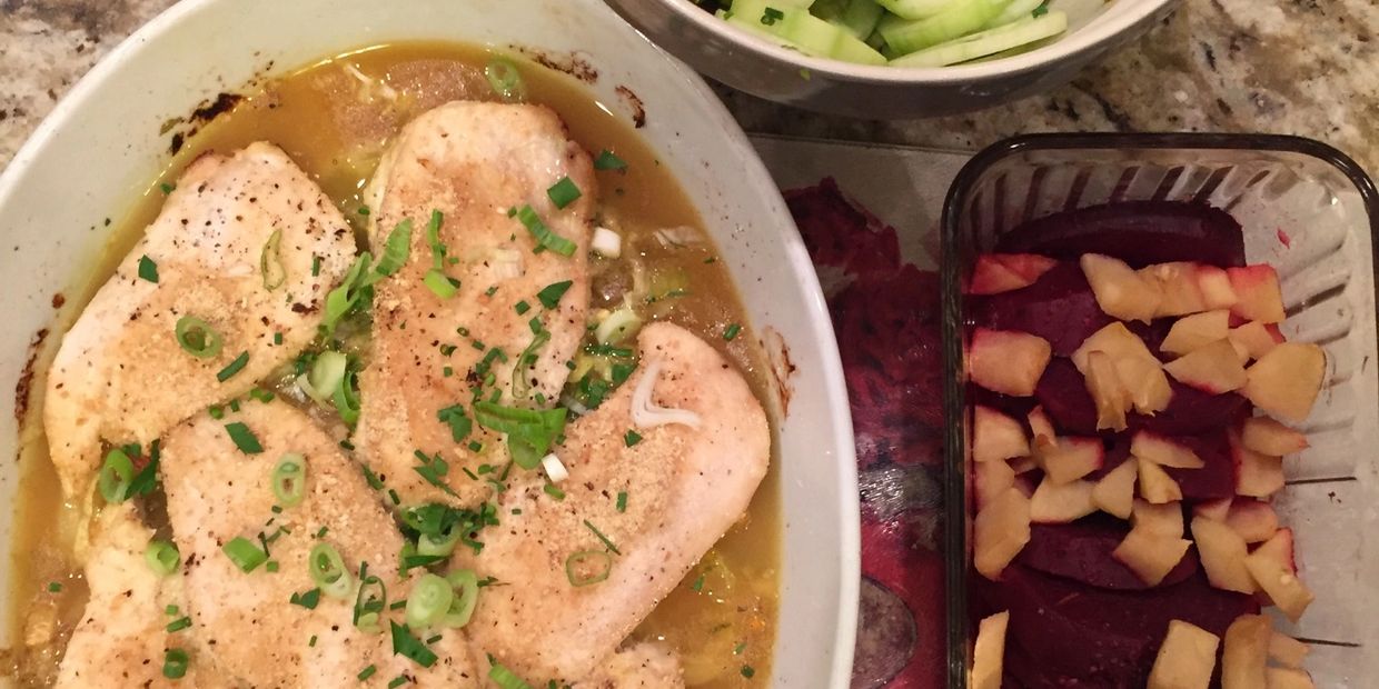 Pork Chops in sauce topped with scallions, cucumber salad