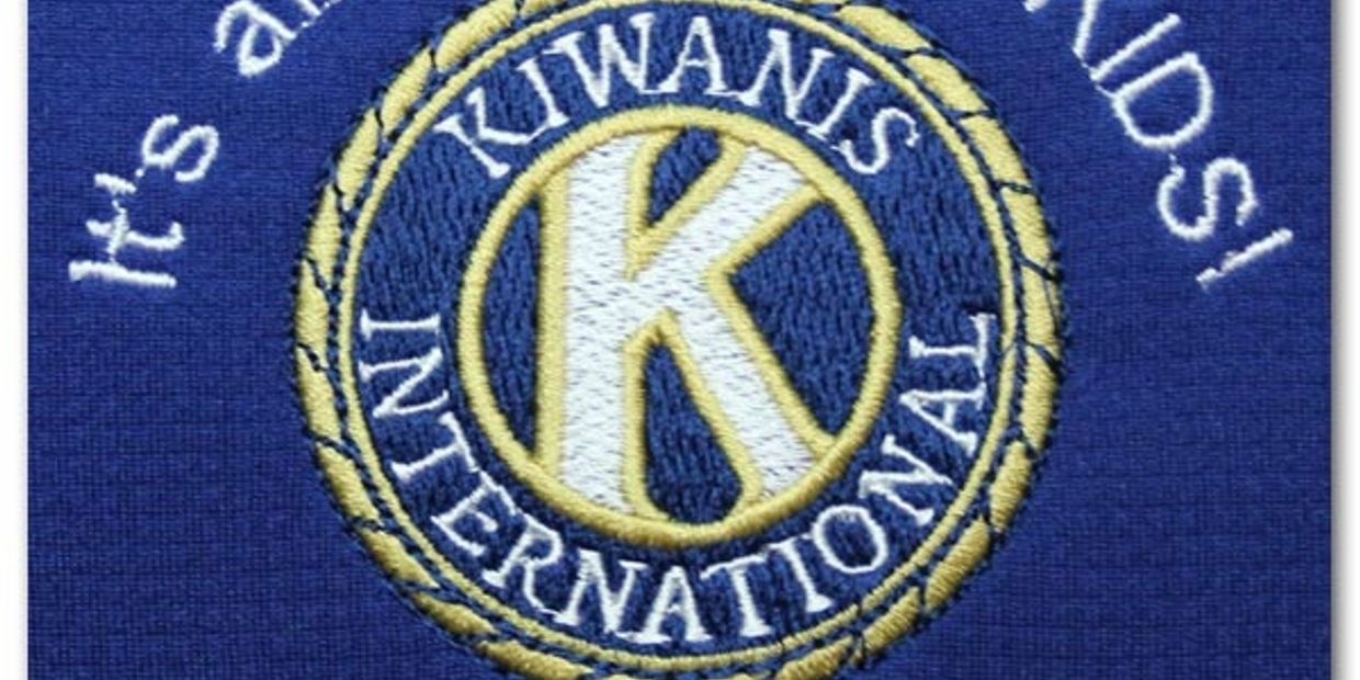 Kiwanis International logo with the slogan 'It's all about the KIDS!' embroidered on blue fabric.
