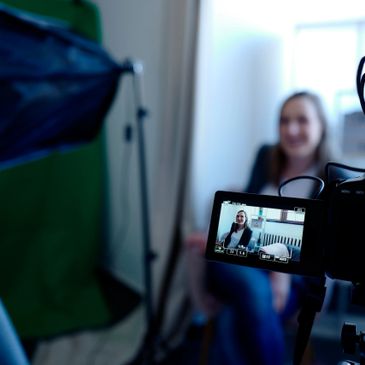 Video monitor and camera with a woman being interviewed - Hathaway PR specializes in broadcast services.