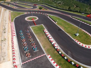 Racing go karts lined up ready for the race on the race track.