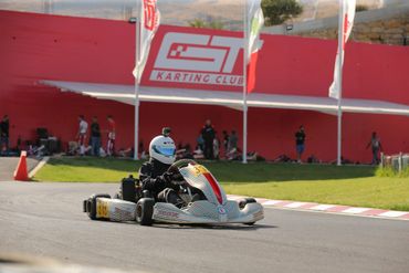 Rotax racer with flags in the background.