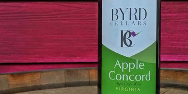 bottle of Byrd Cellars Apple Concord wine on barrel
