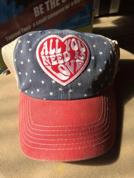 Hat with, "ALL YOU NEED IS LOVE," embroidered patch