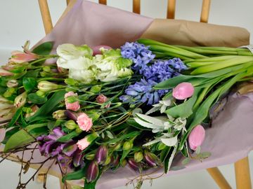 Spring flowers resting on craft paper and lilac tissue paper