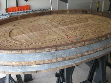 Carved cask on saw horse waiting for final touches.