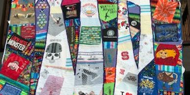A king-size t-shirt quilt made from tshirts, hiking patches, and baby blankets, replicating Sam's ro