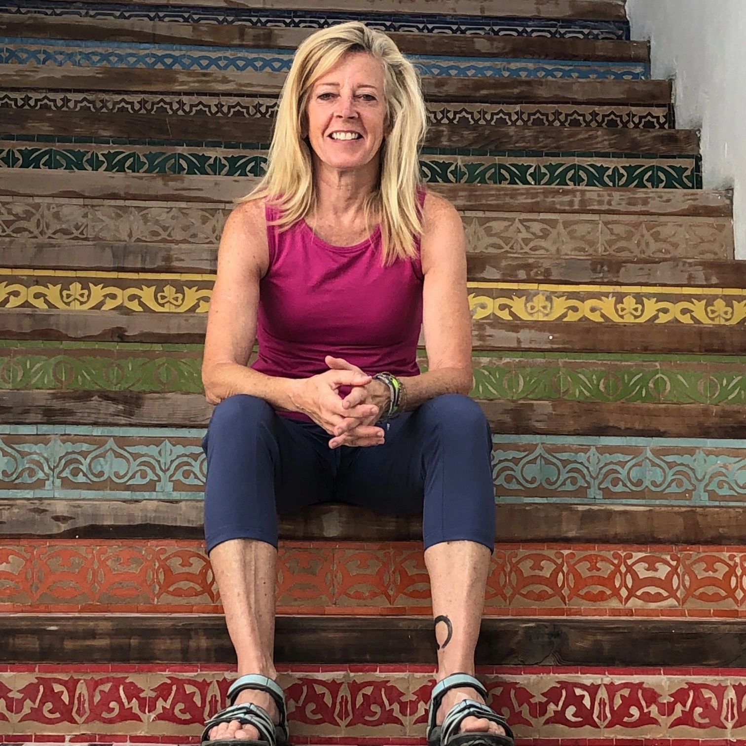 Author sitting on colorful steps in Morocco