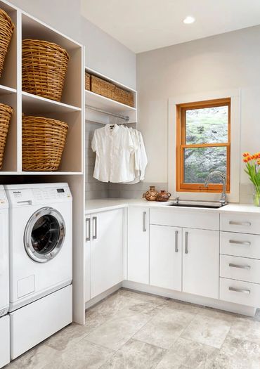 custom laundry room cabinets matte white slab doors hamper basket open shelves wicker 