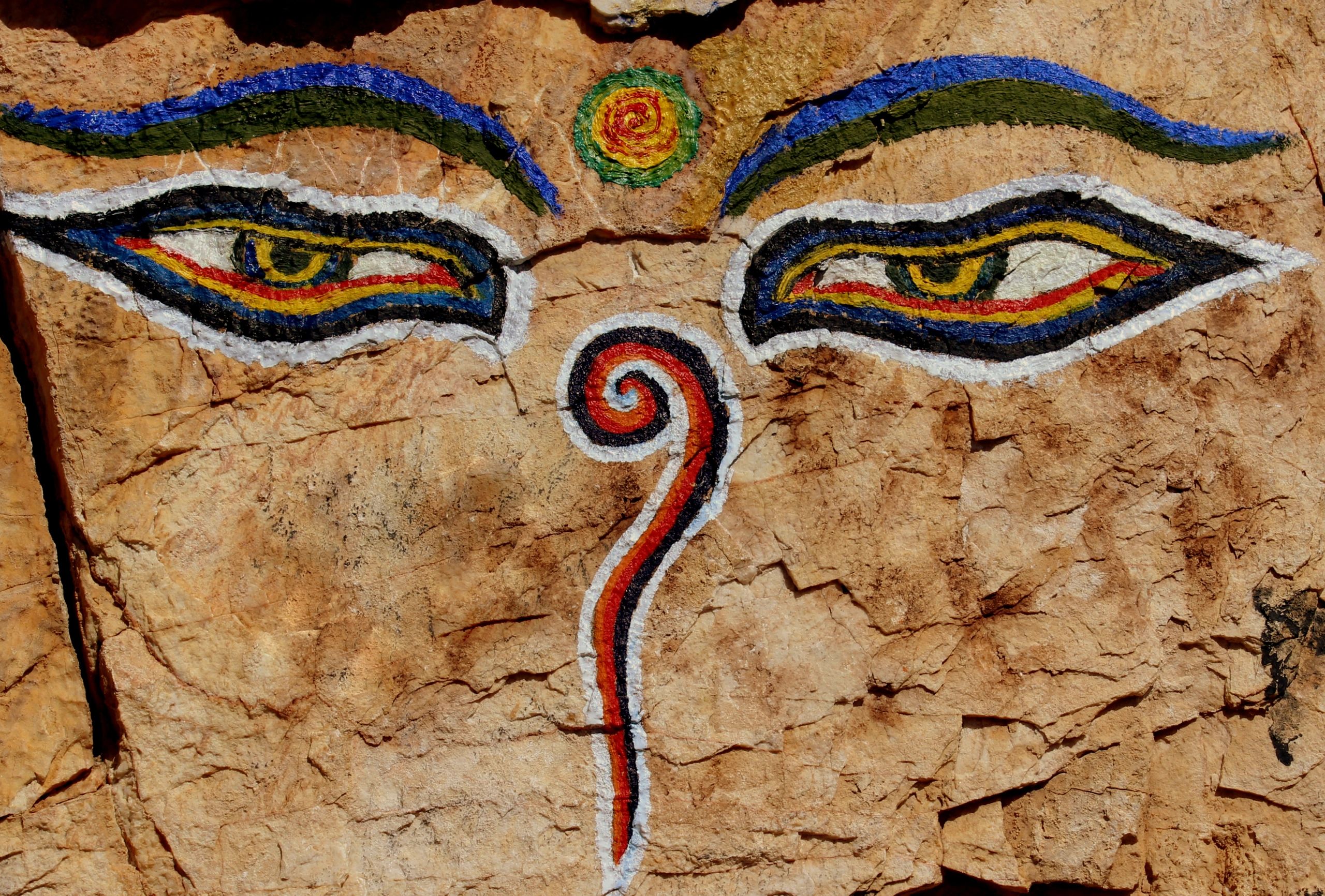 painted face in rock structure