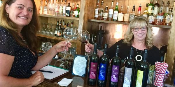 Indira Bayer and restaurant owner tasting Wines of Illyria at a restaurant bar, featuring five wines