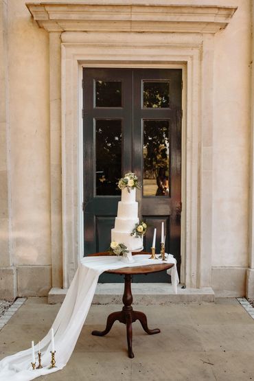 white wedding cake with white and green flowers, classic wedding cake