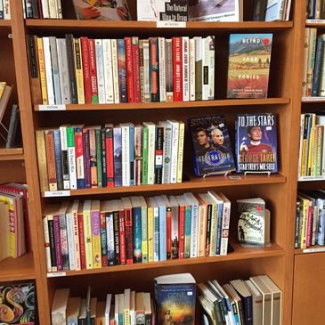 Friends Used Bookstore shelf in the Lindley Perk Coffee Shop at the Bozeman Public Library