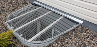 Clear Sloped Custom Window Well Cover.