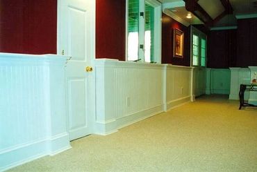 Basement Remodel with tray ceilings, recessed lighting, wainscotting, and beadboard paneling.