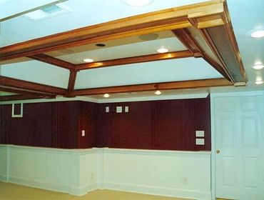 Basement Remodel with tray ceilings, recessed lighting, wainscotting, and a custom trim package. 