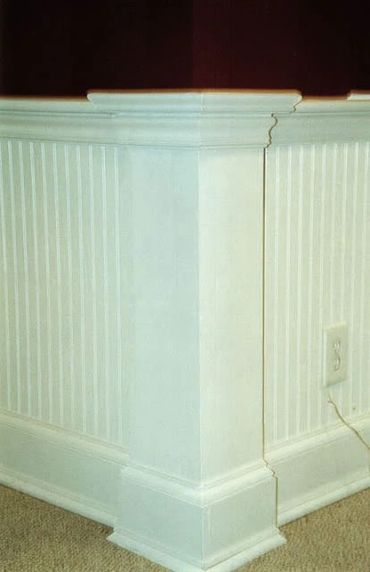 Beadboard paneling with corner columns with four-stage routed molding and baseboards