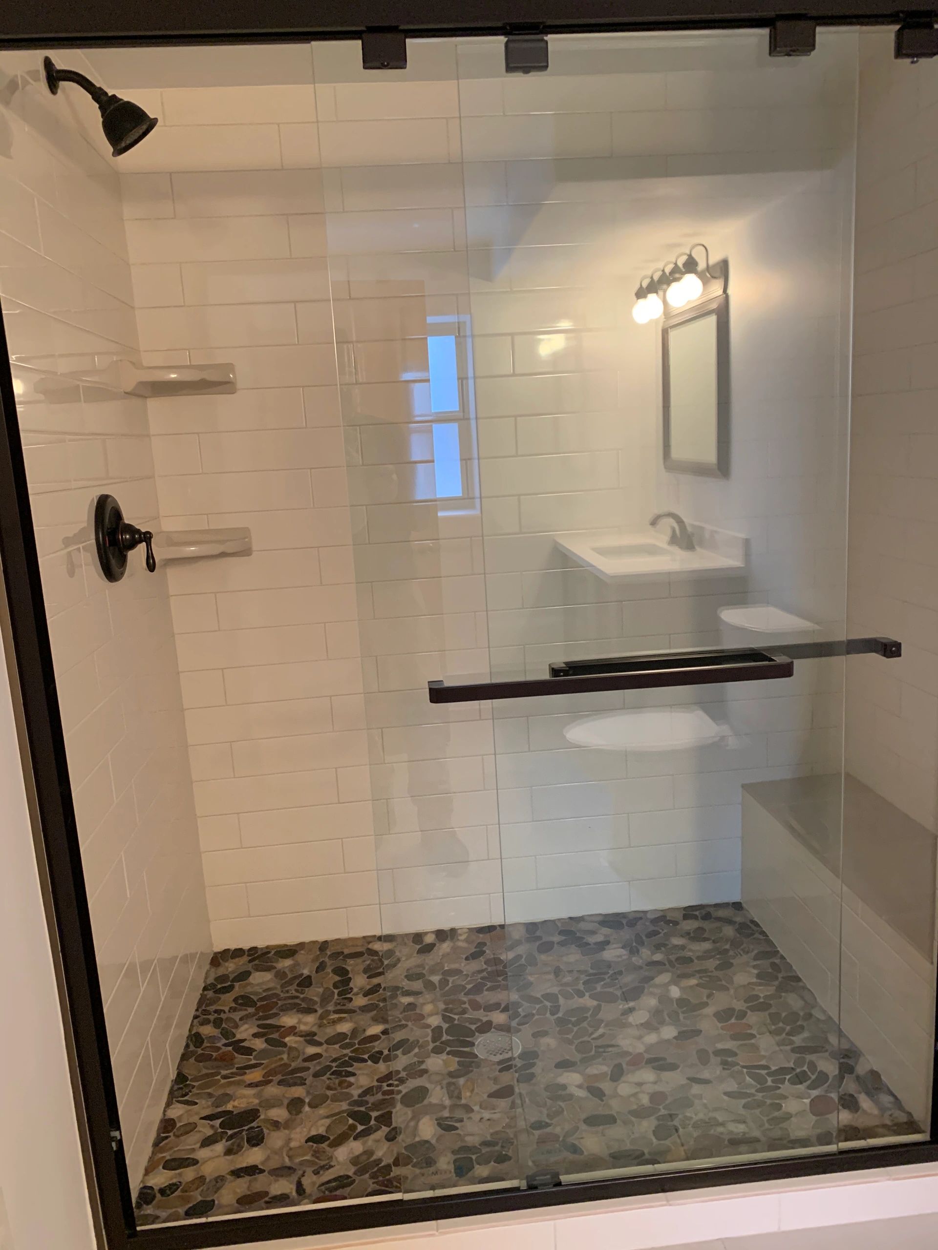 Shower tile installation. Sliding glass door installation. Custom-made shower bench.