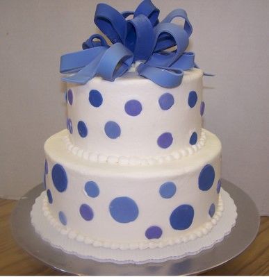 Two tiers of Gluten Free cake with butter cream icing and gumpaste bow.
