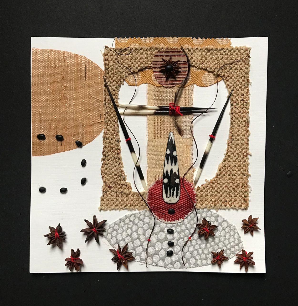 "aligned with the stars"  collage, 12"x12" fabric, african bead, star anise,black beans,on paper