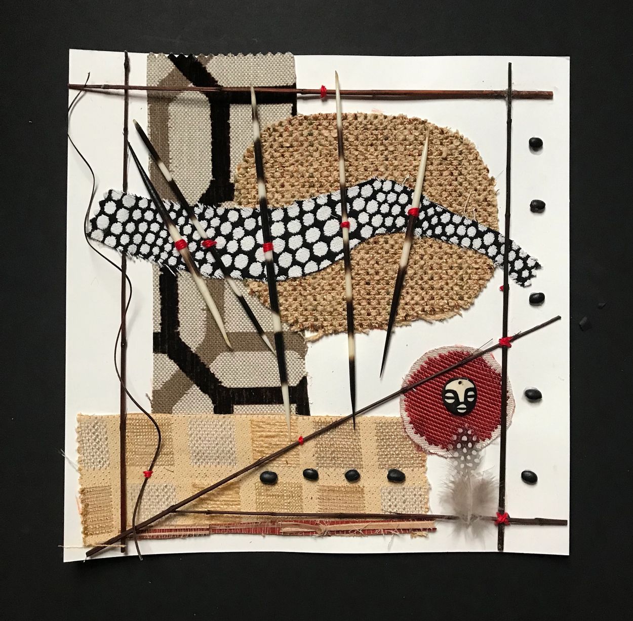 "Planting Seeds" collage,  12"x 12" fabric,black beans,porcupine quills,sticks, thread on paper