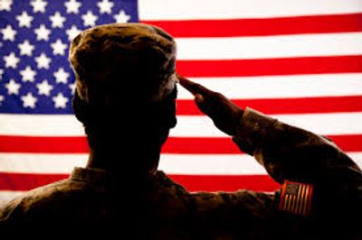 Soldier saluting a American flag.