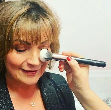 Celebrity Lorraine Kelly having her makeup done with her own set of personalised makeup brushes