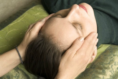 Hands on both side of the head in a Reiki healing session - Chinese Medicine Bristol
