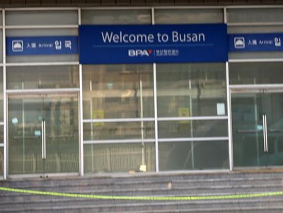 a welcome to busan sign in front of a building