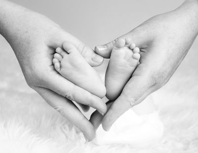 A mother holding her baby’s feet