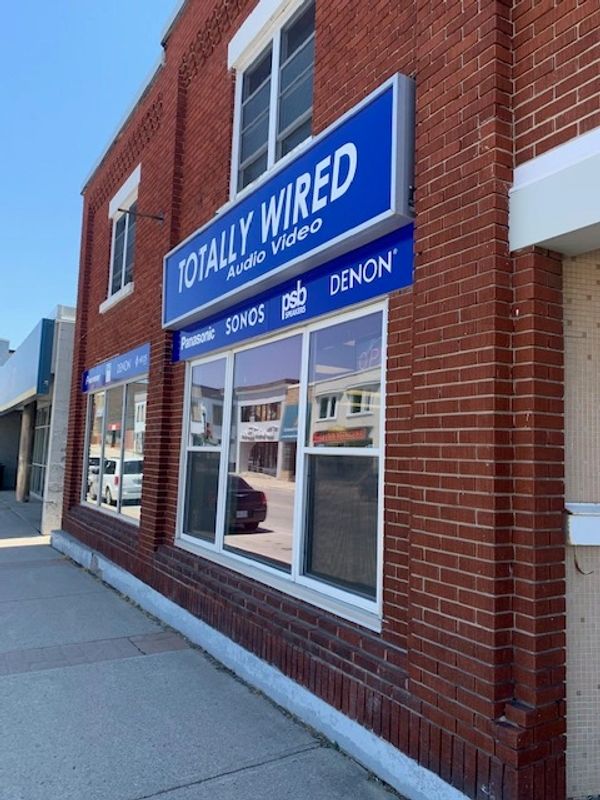 Brick building with Totally Wired Audio Video store sign.
