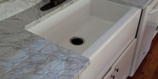 Marble kitchen counter top with white farm sink