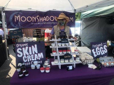 a man with masks selling skin creams