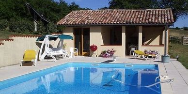 The swimming pool from the house end to the Pool House offering summer shade