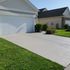 Results of a residential driveway power washed and professionally sealed by Mr. Scrub. 