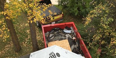 Alberta Strong Roofing's Dump Trailer with the waste of old roof at Alberta beach 